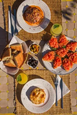 a table with plates of food on top at Riad Tecla in Marrakech