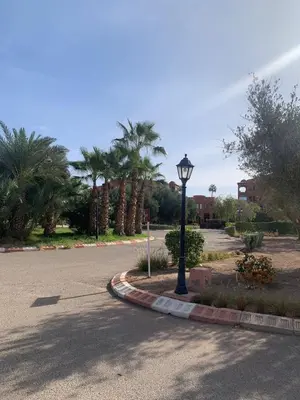 a street light on the side of a road at My Palm House Marrakech avec piscine privée in Marrakech