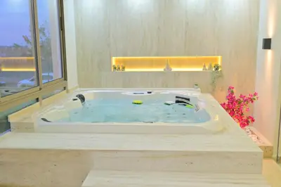 a jacuzzi tub in a bathroom with a window at Luxury apartment with jaccuzi in Marrakech