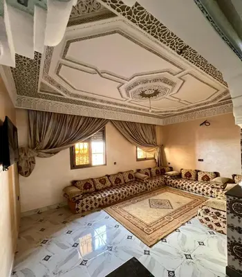 a living room with a couch and a coffered ceiling at Appartement spacieux marocain traditionnel familial in Marrakech