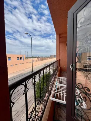 a balcony with a view of the beach from a building at Appartement spacieux marocain traditionnel familial in Marrakech