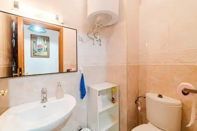 a bathroom with a sink and a toilet and a mirror at Appartement Malika Gueliz in Marrakech