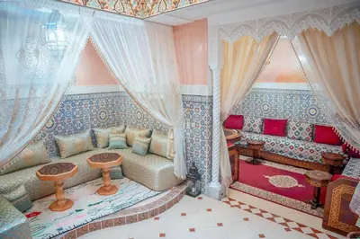 a living room with a couch and curtains at Charming Private Riad in Marrakech
