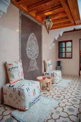a living room with a couch and a table at Charming Private Riad in Marrakech