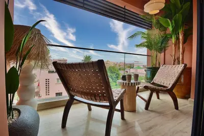 a balcony with two chairs and a table in front of a window at Central Luxury Quiet Hivernage 2 Balconies With View in Marrakech