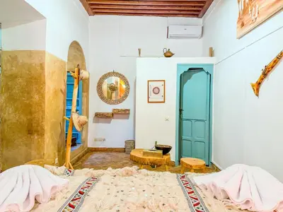 a room with a bed and a table at Riad medina d'or in Marrakech