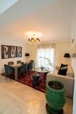 a living room with a couch and a table at Un magnifique appartement avec jardin à Marrakech in Marrakech