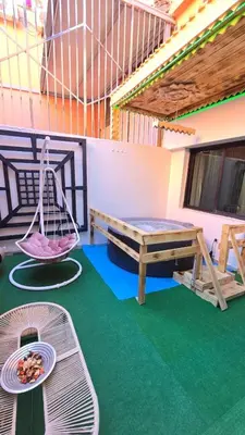 a room with a hammock and a table and a bench at Luxury Penthouse and Jacuzzi at Hivernage in Marrakech