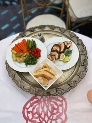 a tray with plates of food on a table at Riad Serendip in Marrakech
