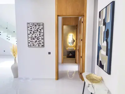 a hallway with white walls and white floors and a doorway at VILLA DE LUXE à Marrakech, GOLF, Piscine, 10 min du centre in Marrakech