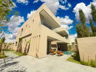 a sustainable house with a pool in front of it at VILLA DE LUXE à Marrakech, GOLF, Piscine, 10 min du centre in Marrakech