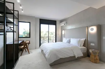 a bedroom with a large bed and a desk in it at The view City Center in Marrakech
