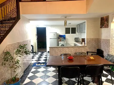 a kitchen with a table and chairs in a room at Maison Marrakech in Marrakech