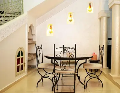 a dining room with a table and chairs at New Stylish Riad - 4BR with Pool Access in Marrakech