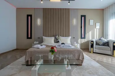 a bedroom with a bed and a glass table at Villa Mareva & Spa Marrakech in Marrakech