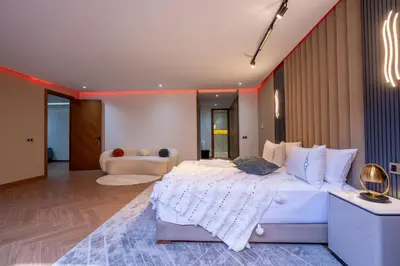 a bedroom with a large white bed and a couch at Villa Mareva & Spa Marrakech in Marrakech