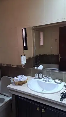 a bathroom with a sink and a mirror at Appartement tres aimable in Marrakech
