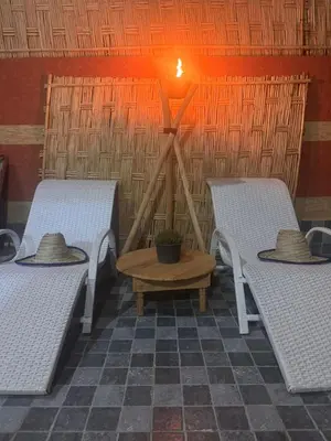 two beds with hats and a table in a room at Villa cosy & pool Marrakech in Marrakech