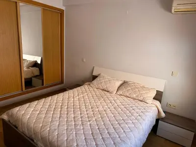 a bedroom with a bed and a large mirror at Appartement chaleureux au cœur de Marrakech in Marrakech