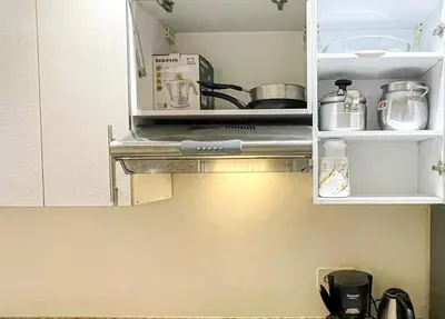 a kitchen with a stove and a cupboard at Luxury Aprt 2-bedrooms-Pool Hivernage City Centre-Free Parking in Marrakech