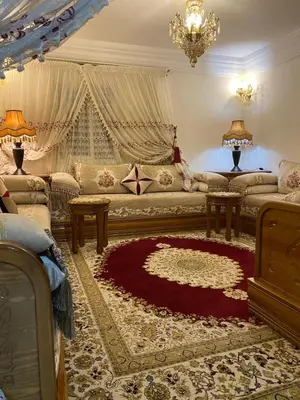a living room with a couch and a red rug at Youssef House Le Village Touristique in Marrakech