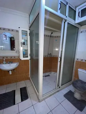a bathroom with a shower and a toilet and a sink at Youssef House Le Village Touristique in Marrakech