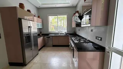 a kitchen with a stainless steel refrigerator and a sink at Private Villa with Pool in Marrakech