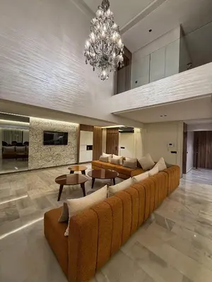 a large living room with a couch and a chandelier at Luxury Serenity Marrakech - Spacious Duplex with Pool in Marrakech
