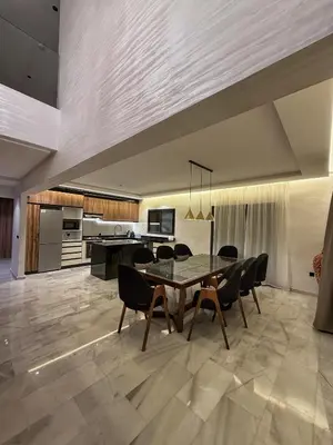 a kitchen and dining room with a table and chairs at Luxury Serenity Marrakech - Spacious Duplex with Pool in Marrakech