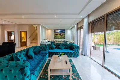 a living room with a blue couch and a table at Villa 3 in Marrakech
