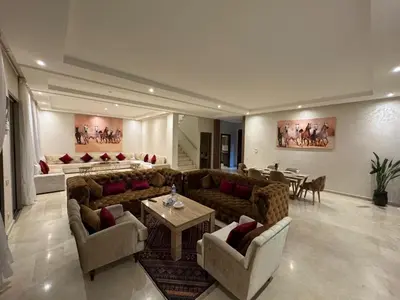 a large living room with couches and a table at Villa 5 in Marrakech