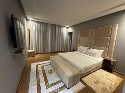 a bedroom with a large bed and a television at Villa 5 in Marrakech