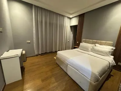 a bedroom with a large bed with white sheets and pillows at Villa 5 in Marrakech