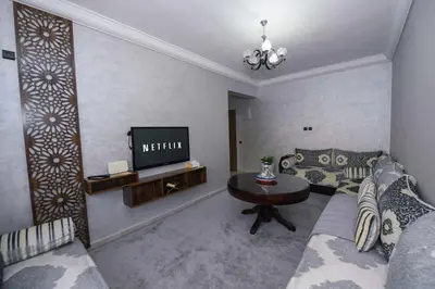 a living room with a couch and a table at Jardin de chrifia cosy in Marrakech