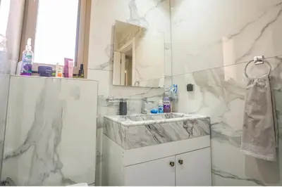 a white bathroom with a sink and a mirror at Luxury golf Prestigia Saphir in Marrakech