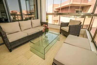 a living room with a couch and a glass table at Luxury golf Prestigia Saphir in Marrakech