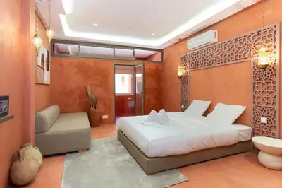 a bedroom with a bed and a couch in a room at Suite Sirocco - Confort a Gueliz in Marrakech