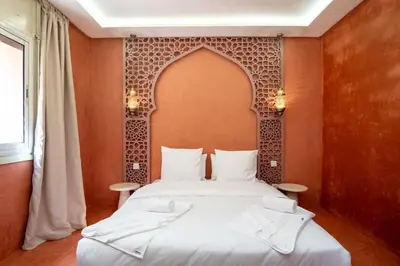 a bedroom with a bed with a moroccan inspired headboard at Suite Safran - Ambiance berbere in Marrakech