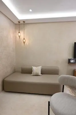 a room with a couch with a pillow on it at Suite Ivoire - Elegance a Gueliz in Marrakech