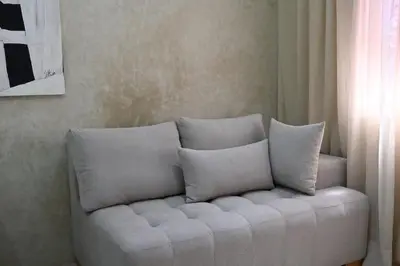 a white couch with pillows in a living room at Suite Dune - Confort et Elegance in Marrakech