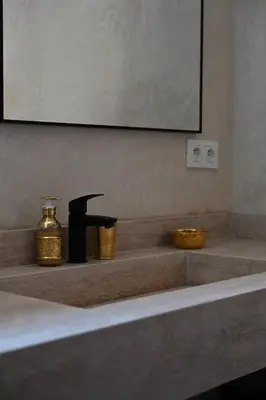 a bathroom sink with a faucet and two bowls at Suite Atlas - Douceur et confort in Marrakech
