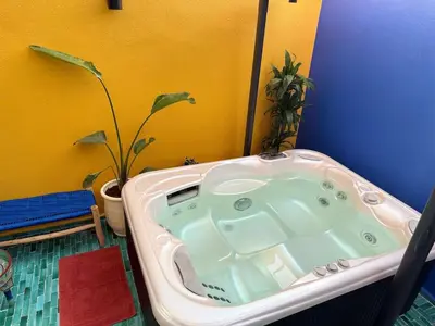 a bath tub in a bathroom with a plant at Beautiful winter apartment with private hot tub in Marrakech
