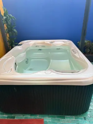 a jacuzzi tub in a bathroom with a blue wall at Beautiful winter apartment with private hot tub in Marrakech