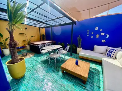 a living room with a couch and a table at Beautiful winter apartment with private hot tub in Marrakech