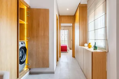 a hallway with a washer and dryer in a house at City Center-1 Queen BR with AC, Pool and IPTV- Parking in Marrakech