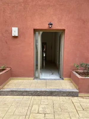 an entrance to a building with a red wall at Very nice apartment on Route de Casa in Marrakech