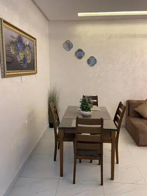 a dining room with a table and chairs at Very nice apartment on Route de Casa in Marrakech