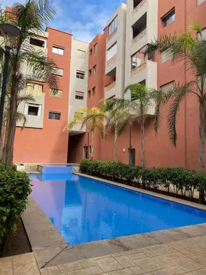 a swimming pool in front of a building at Very nice apartment on Route de Casa in Marrakech