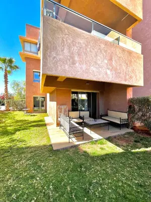 a building with a patio with benches in a yard at Prestihia jade in Marrakech