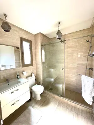 a bathroom with a shower and a toilet and a sink at Prestihia jade in Marrakech